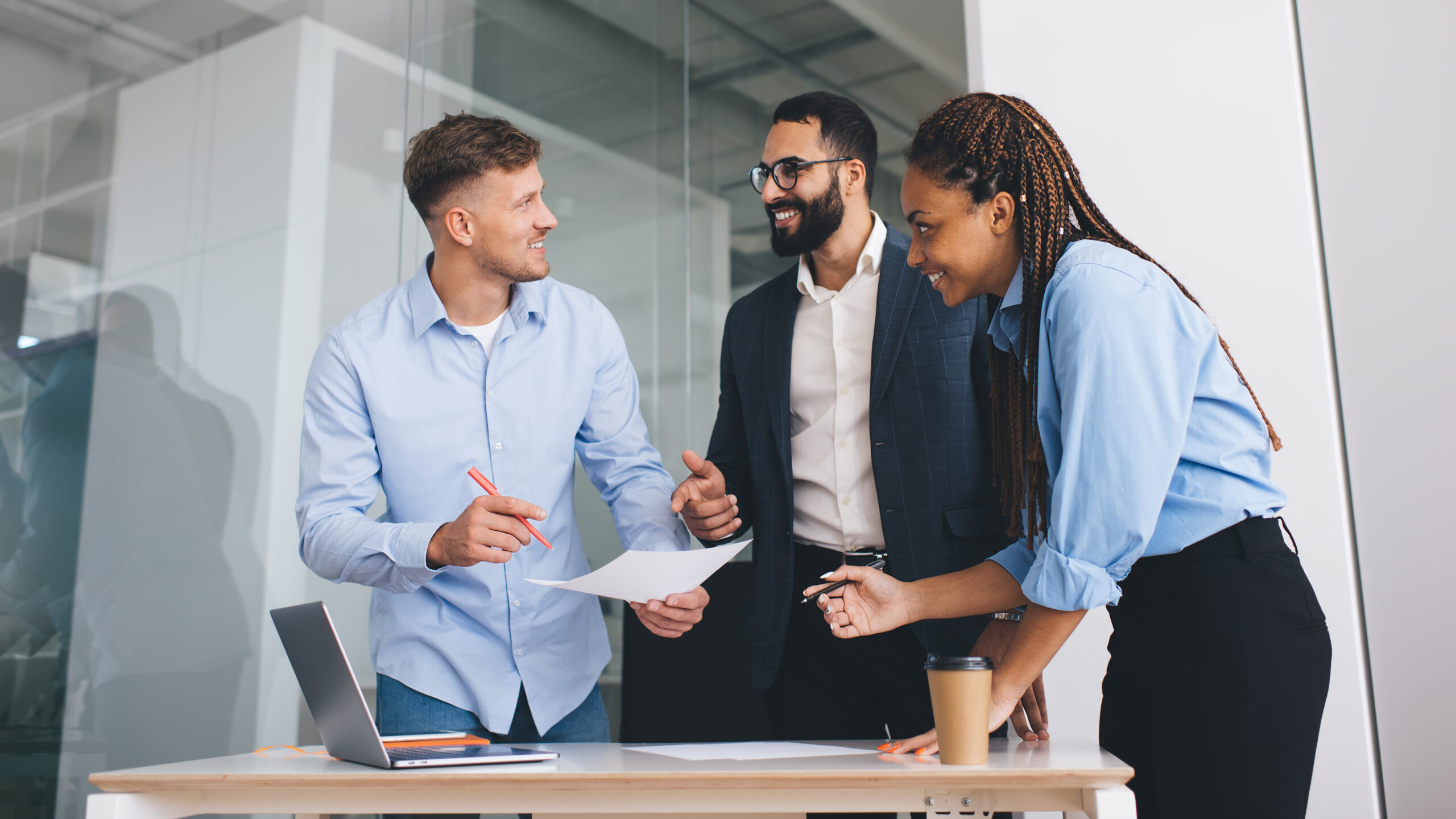 Employees of a company collaborating around a table during a meeting. 